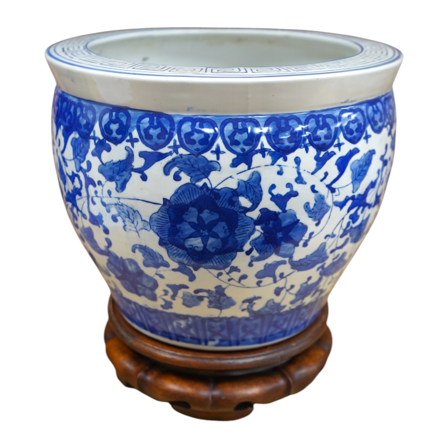 A Chinese blue and white floral jardiniere on hardwood stand, overall 32cm high. Condition - good